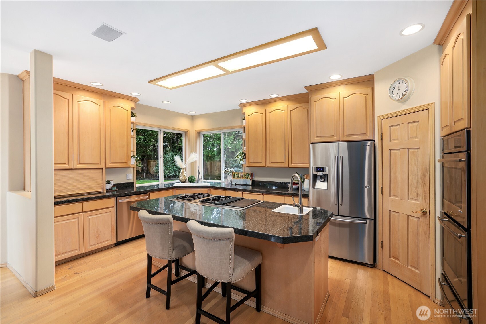 423 Southwest 348th Court Federal Way, WA 98023 - Photo 10 of 39 a kitchen with granite countertop a refrigerator a stove a sink and white cabinets with wooden floor