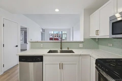 a kitchen with stainless steel appliances granite countertop a sink stove and cabinets