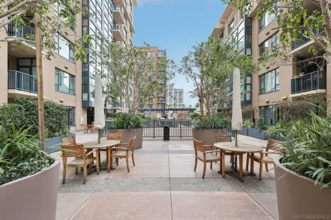 a view of a patio with a table and chairs and potted plants