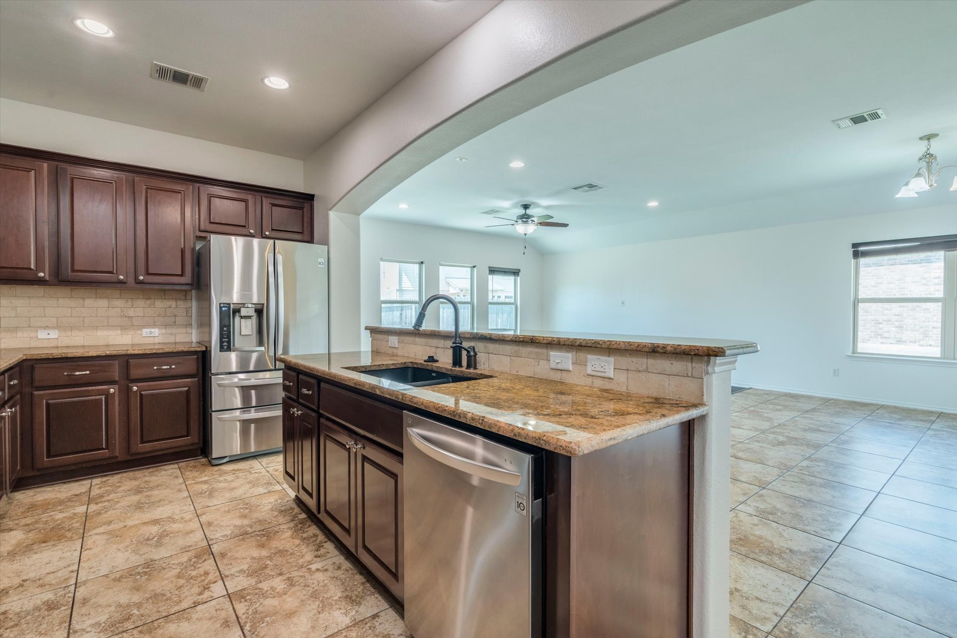 16829 Ruggio Road Pflugerville, TX 78660 - Photo 12 of 40 a kitchen with a stove sink and refrigerator