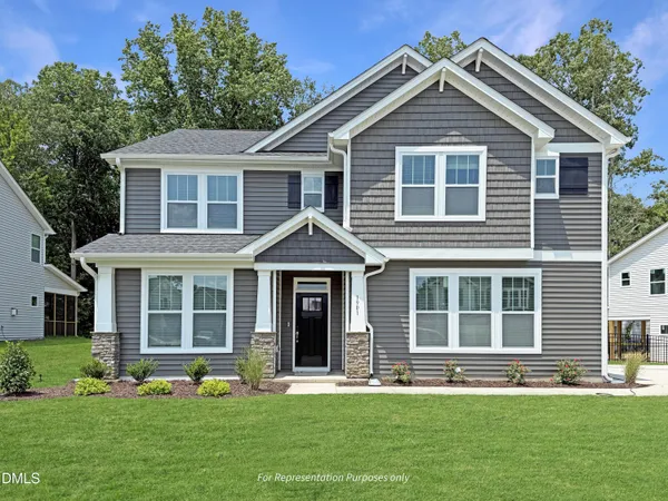 a front view of a house with a yard and porch