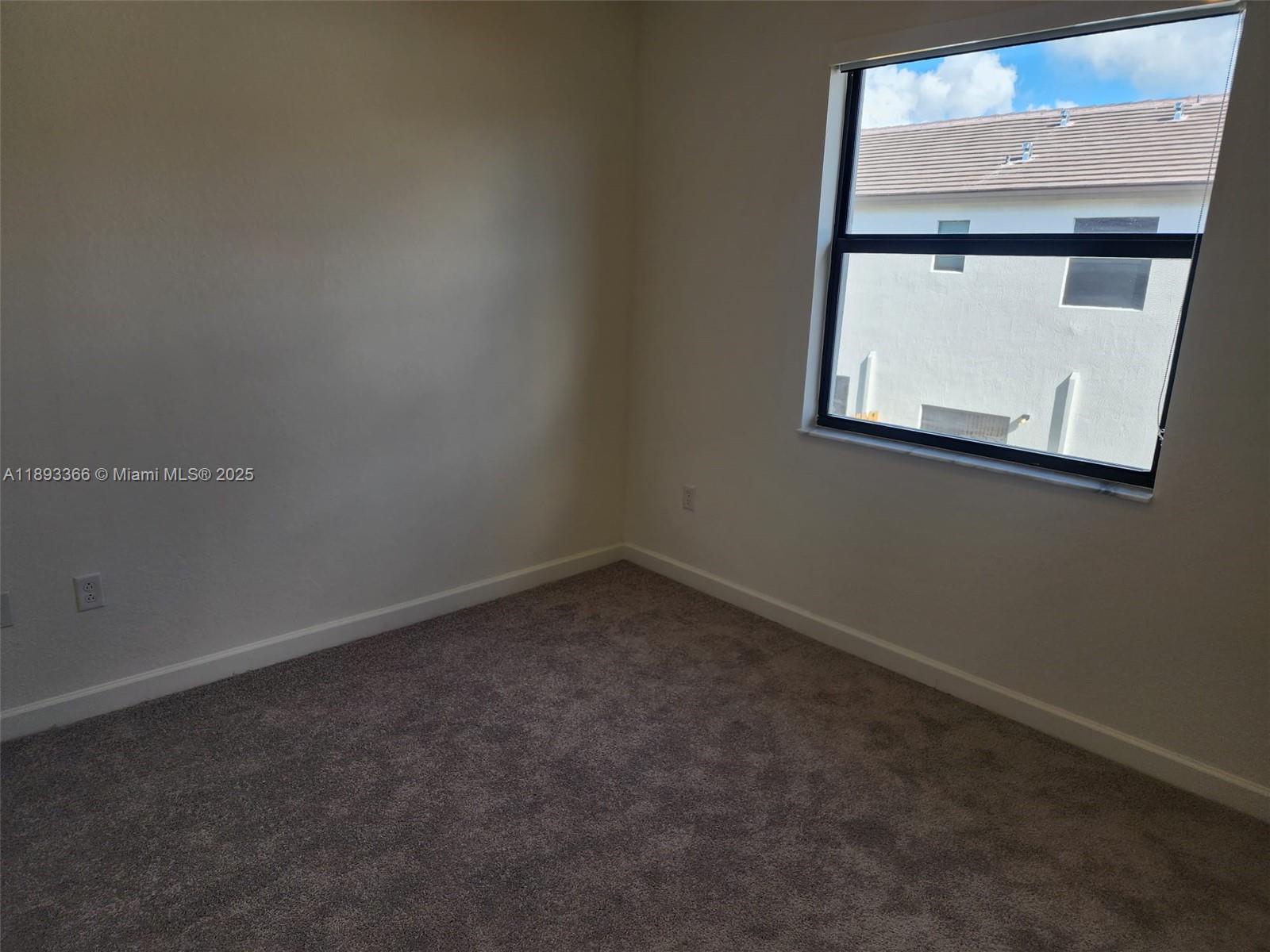 12867 Southwest 232nd Lane, Unit 12867 Homestead, FL 33032 - Photo 11 of 12 an empty room with a window