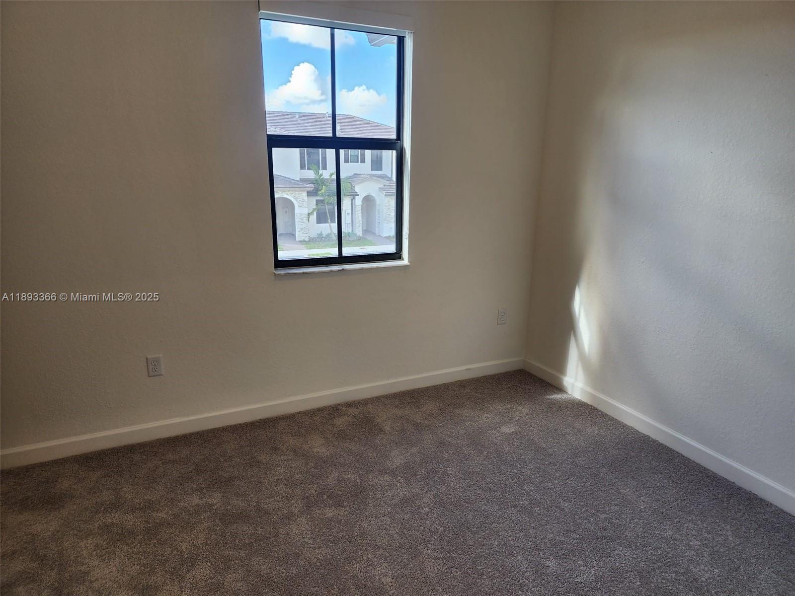 12867 Southwest 232nd Lane, Unit 12867 Homestead, FL 33032 - Photo 9 of 12 an empty room with windows and closet