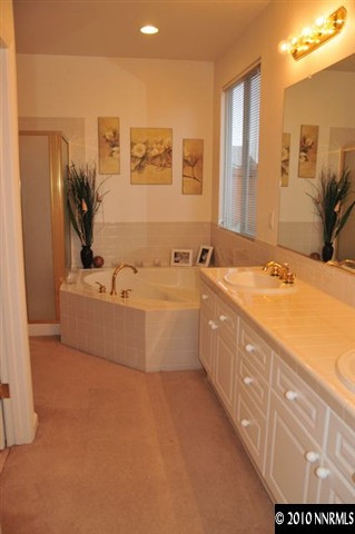 1895 San Pablo Drive Reno, NV 89521 - Photo 8 of 9 a bathroom with a sink double vanity granite tub shower and a mirror