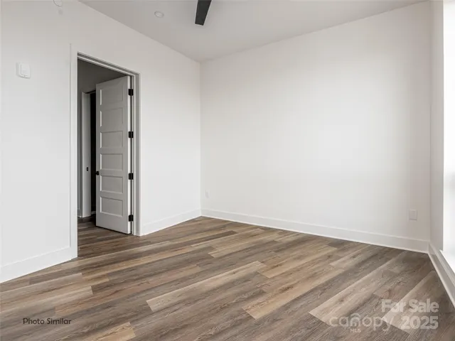 an empty room with wooden floor and closet