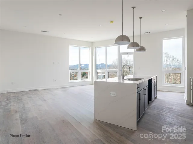 a kitchen with kitchen island and a large window