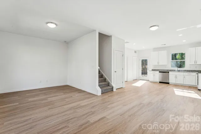 a view of kitchen with wooden floor and electronic appliances