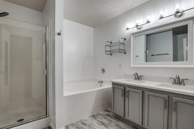 a bathroom with a tub a sink and mirror