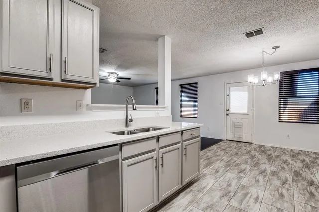 a kitchen with a sink and cabinets