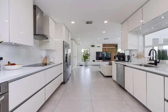 a kitchen with a refrigerator and a sink