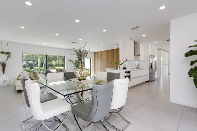 a kitchen with stainless steel appliances kitchen island granite countertop a refrigerator and a stove top oven