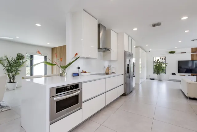 a kitchen with stainless steel appliances granite countertop a sink and cabinets