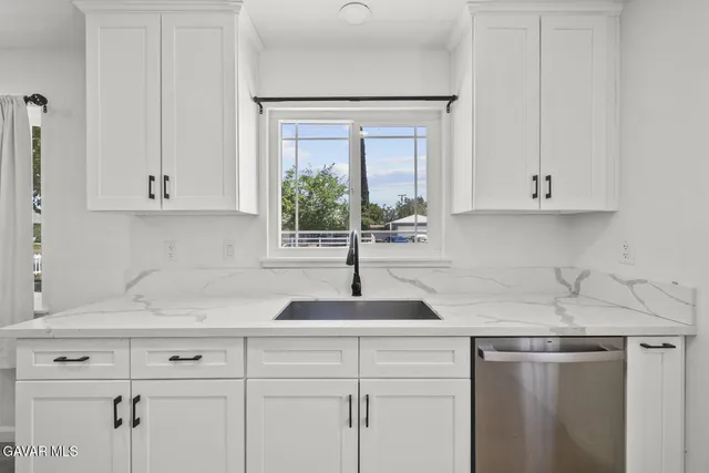 a view of a kitchen with wooden floor and a sink