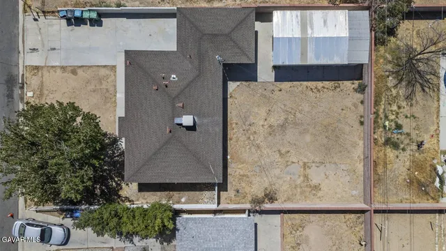 an aerial view of a house with a garden and trees