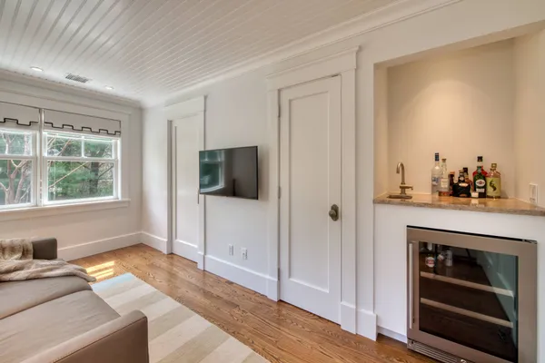 a bed sitting in a bedroom next to a window