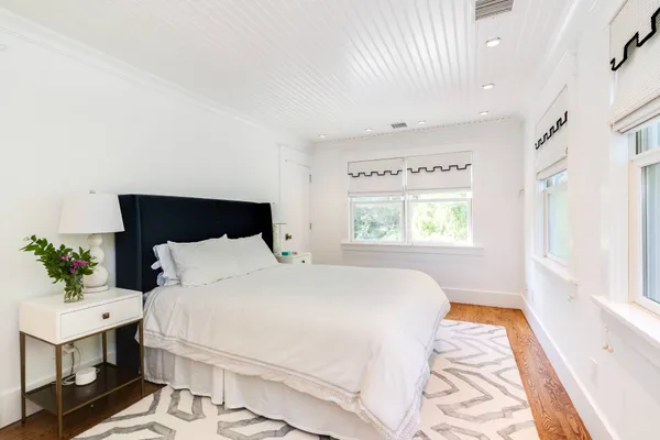 a bathroom with a tub sink shower and mirror