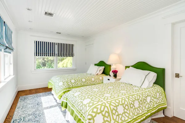 a bedroom with a bed and a wooden floor