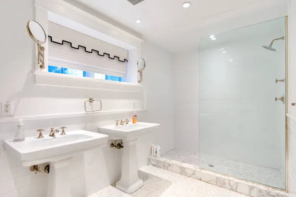 a view of a house with a yard and potted plants