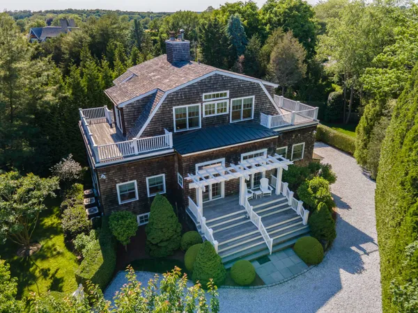 an aerial view of a house with a yard porch and furniture