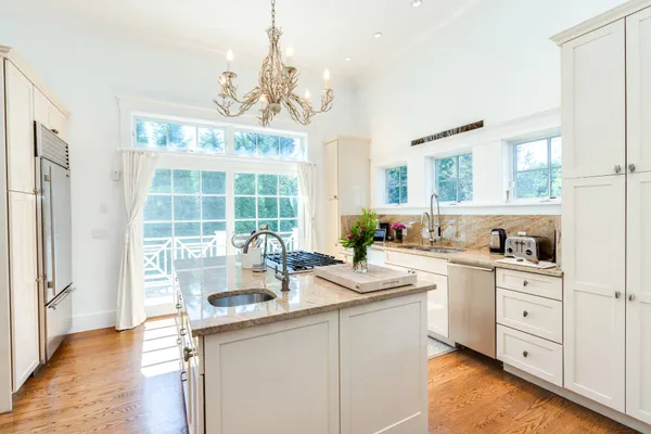 a kitchen with a sink stove and cabinets