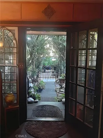 a view of a backyard with plants and a bench
