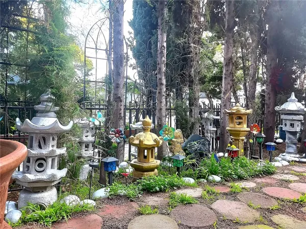 a view of a pathway with flower plants
