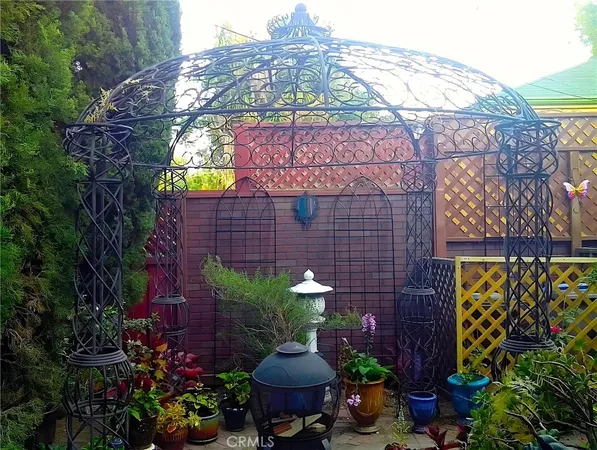 a view of a backyard with plants and flowers