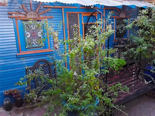 a view of a patio with table and chairs and potted plants