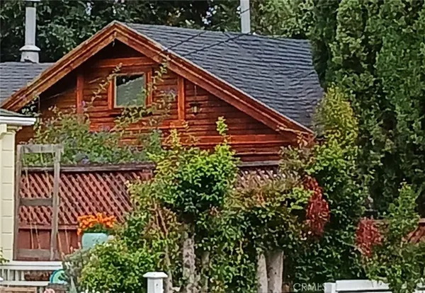 a view of a house with a window and a yard