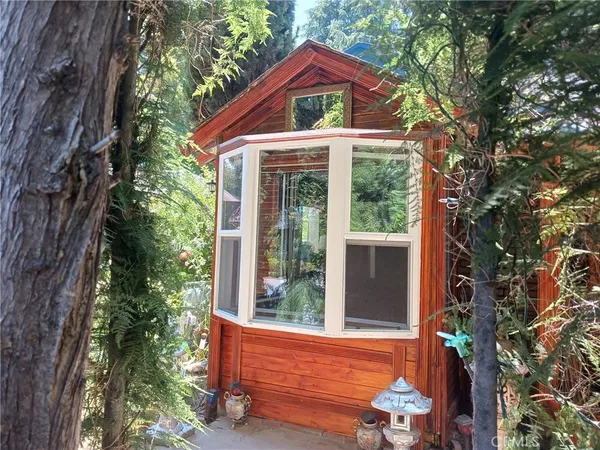 a backyard of a house with yard barbeque oven and outdoor seating