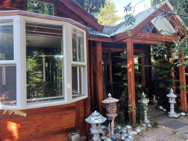 a view of a brick house with a dining table and chairs