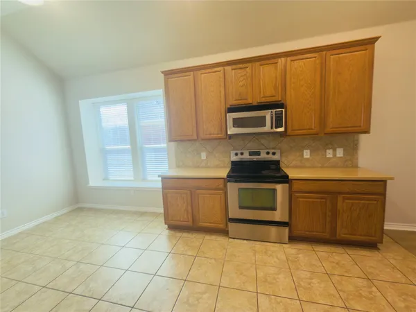 a kitchen with stainless steel appliances a refrigerator sink and cabinets