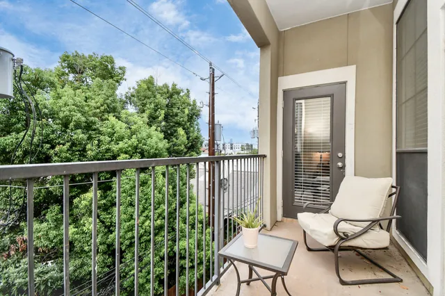 a view of a chair and table in the balcony