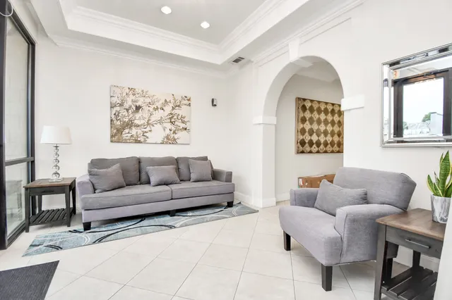 a living room with furniture and a painting on the wall