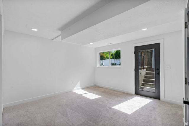 432 Calnette Drive Sandy, UT 84070 - Photo 22 of 48 Carpeted room with recessed lighting, a single window, and a dark-framed exterior door with integrated glass panel