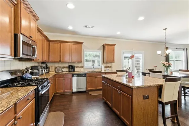 a kitchen with sink cabinets and wooden floor