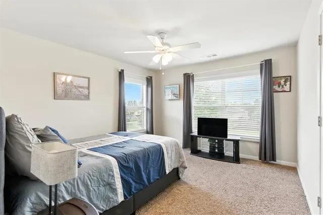 a bedroom with furniture and a flat screen tv