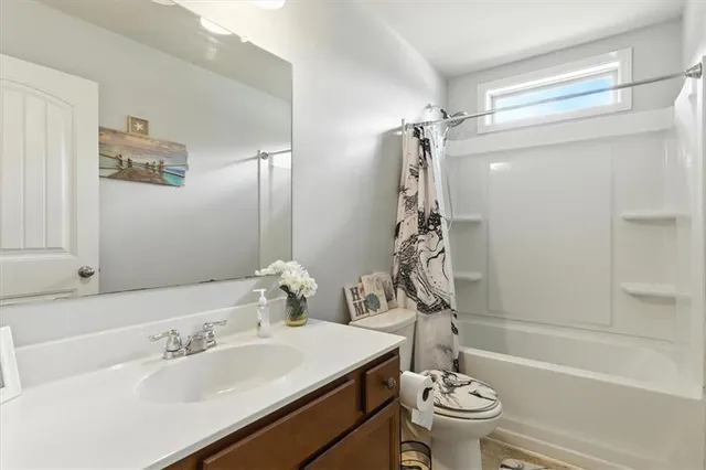 a bathroom with a sink mirror and toilet