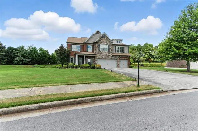 a front view of a house with a yard and garage