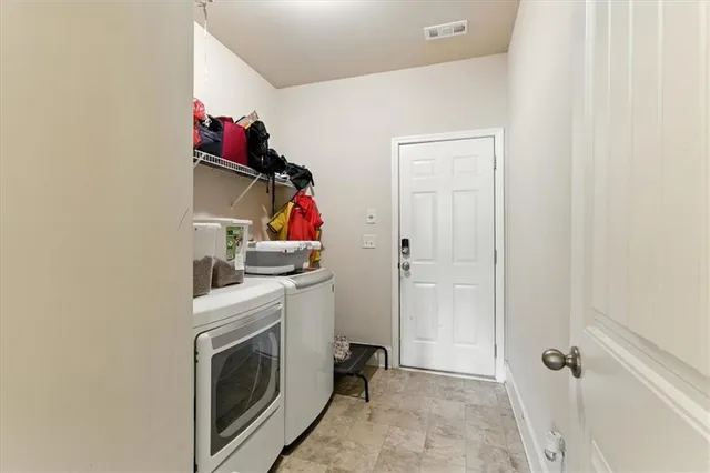 a view of green field with trees in the background