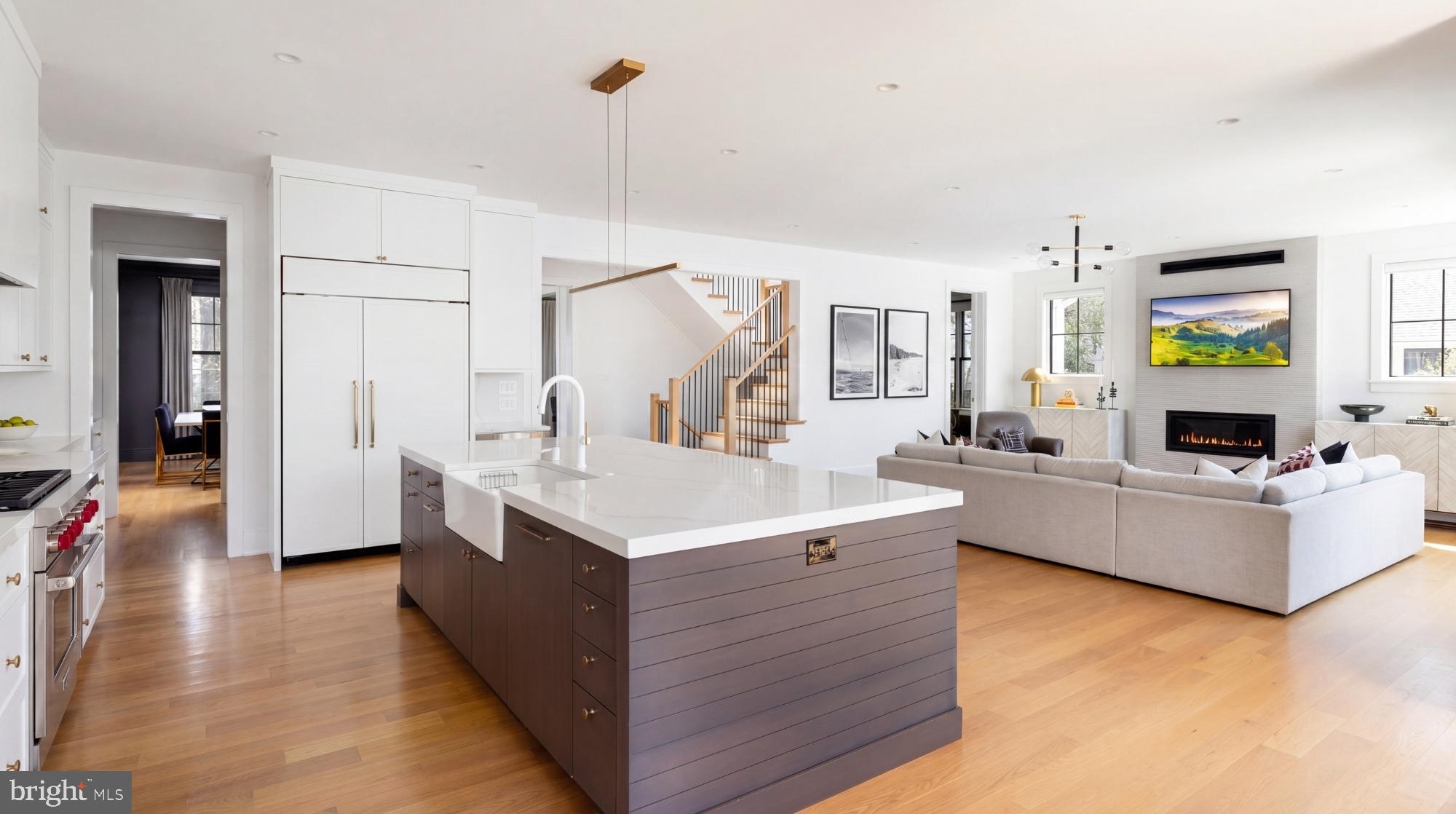 7208 Ridgewood Avenue Chevy Chase, MD 20815 - Photo 11 of 50 a large white kitchen with cabinets and a wooden floors