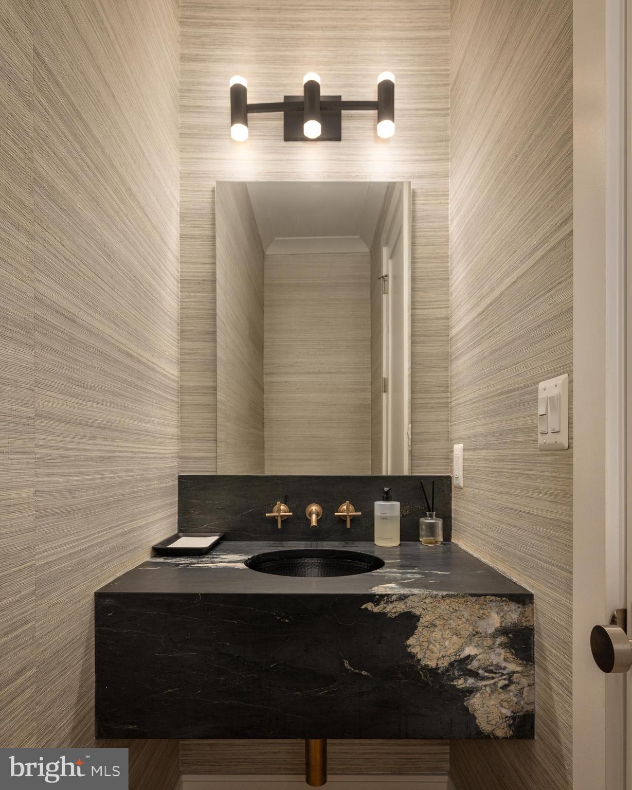 7208 Ridgewood Avenue Chevy Chase, MD 20815 - Photo 25 of 50 a bathroom with a sink and a mirror