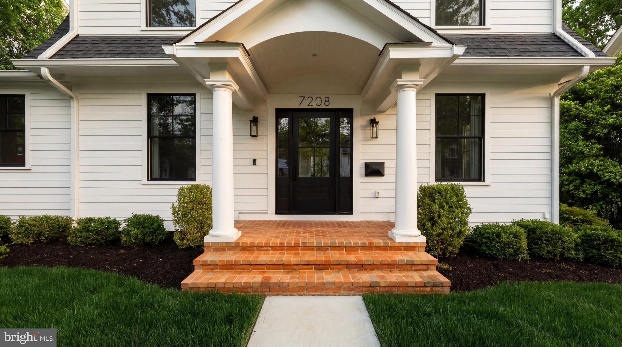 7208 Ridgewood Avenue Chevy Chase, MD 20815 - Photo 3 of 50 a front view of a house with a garden