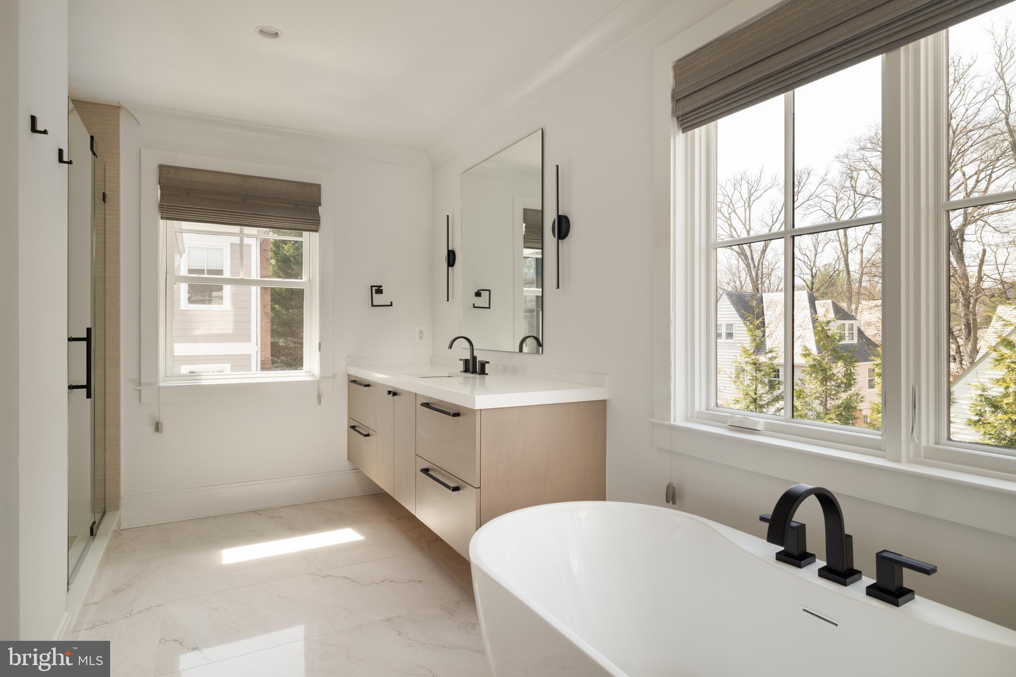 7208 Ridgewood Avenue Chevy Chase, MD 20815 - Photo 32 of 50 a bathroom with a tub sink double vanity window and mirror