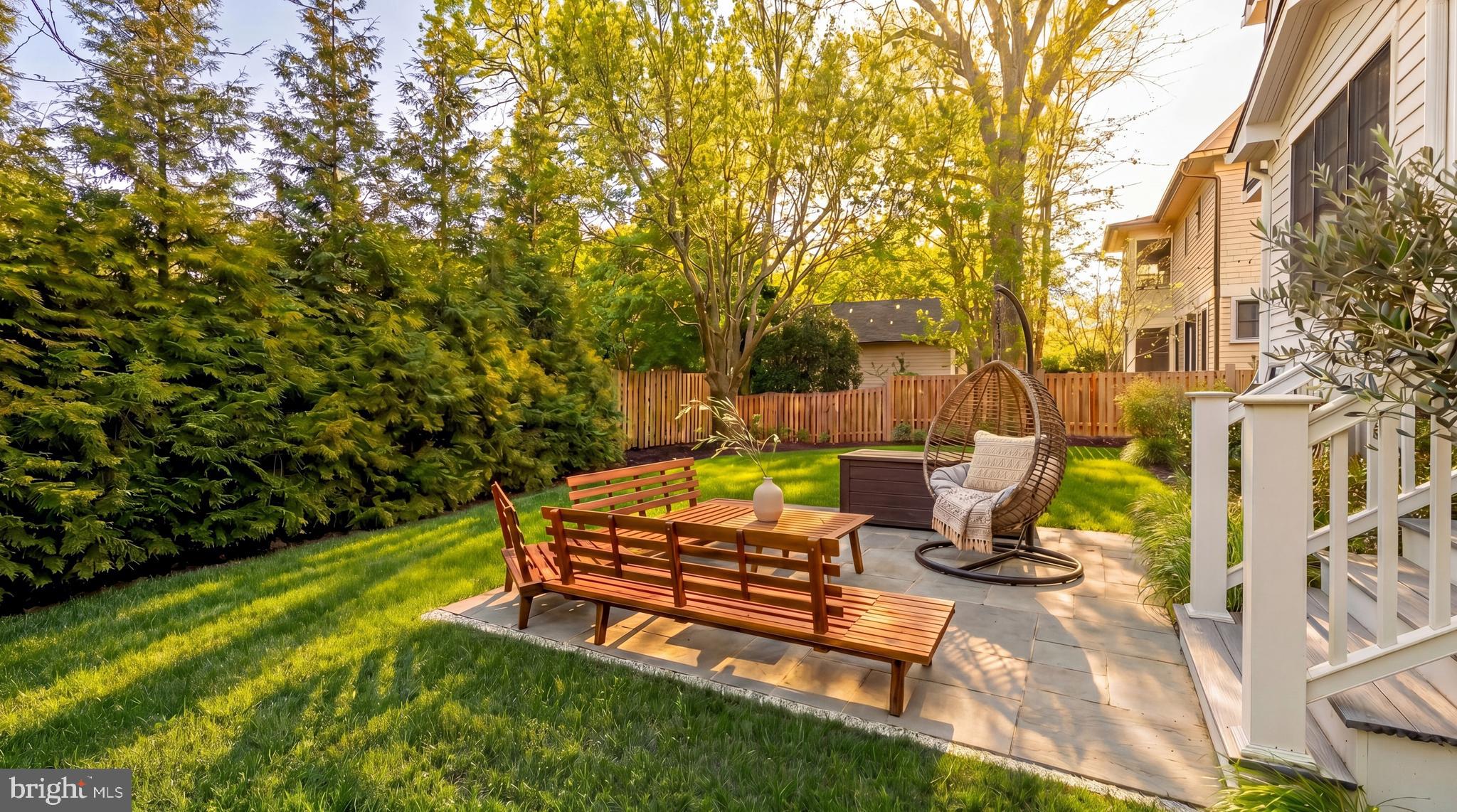 7208 Ridgewood Avenue Chevy Chase, MD 20815 - Photo 46 of 50 a view of a patio with table and chairs and potted plants with wooden floor and fence