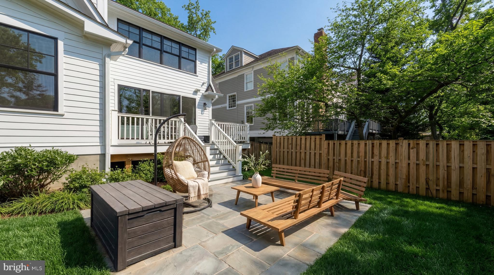 7208 Ridgewood Avenue Chevy Chase, MD 20815 - Photo 47 of 50 a view of a backyard with a large tree and wooden fence