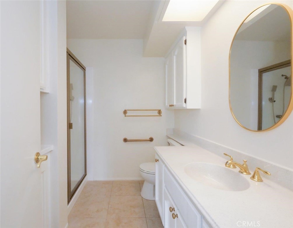 13601 Del Monte Drive, Unit 75 Seal Beach, CA 90740 - Photo 24 of 28 a bathroom with a sink a toilet and shower