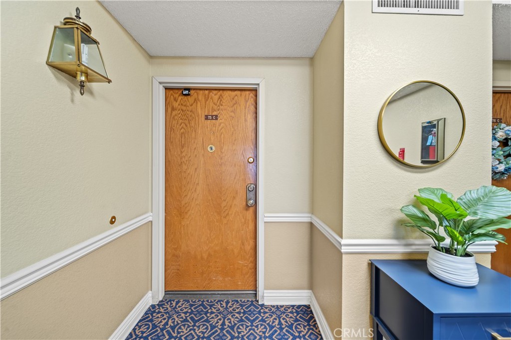 13601 Del Monte Drive, Unit 75 Seal Beach, CA 90740 - Photo 3 of 28 a bath room with a sink and a mirror