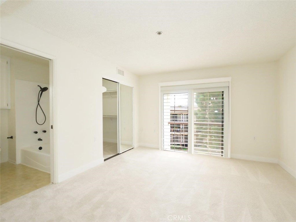 13601 Del Monte Drive, Unit 75 Seal Beach, CA 90740 - Photo 7 of 28 an empty room with windows