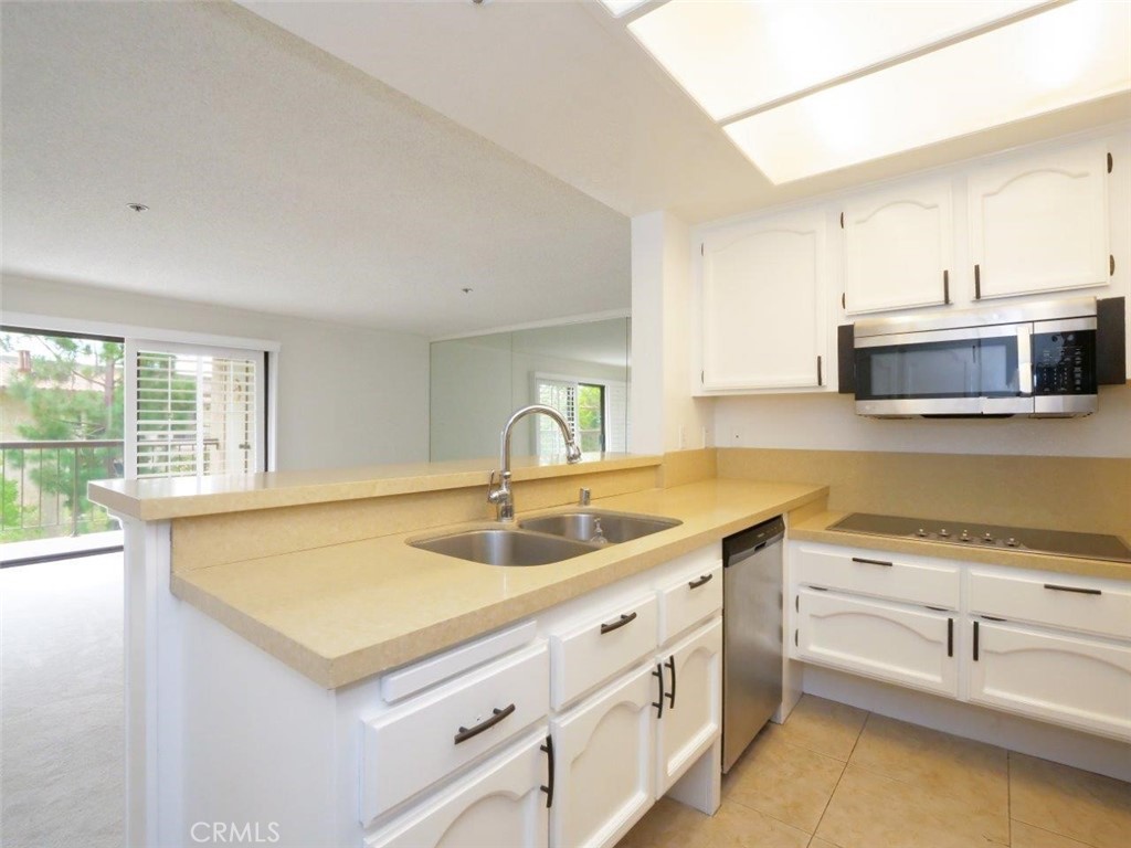 13601 Del Monte Drive, Unit 75 Seal Beach, CA 90740 - Photo 9 of 28 a kitchen with a sink and a microwave